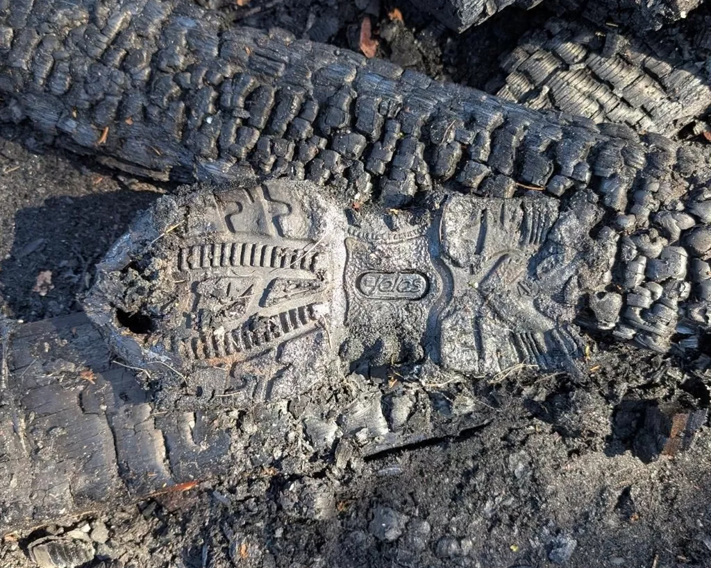 A JALAS outsole lying intact among the ashes after a fire.